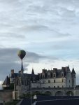 illusion of hot air balloon perched on steeple of royal chateau
